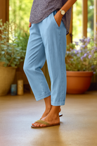 Rear view of the Avani elegant lightweight trousers in grey, demonstrating the flattering drape and elegant silhouette.