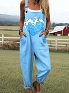 Front view of the light blue Briar Cloud Heart Jumpsuit, featuring a large white heart graphic with cloud accents, styled on a mannequin.