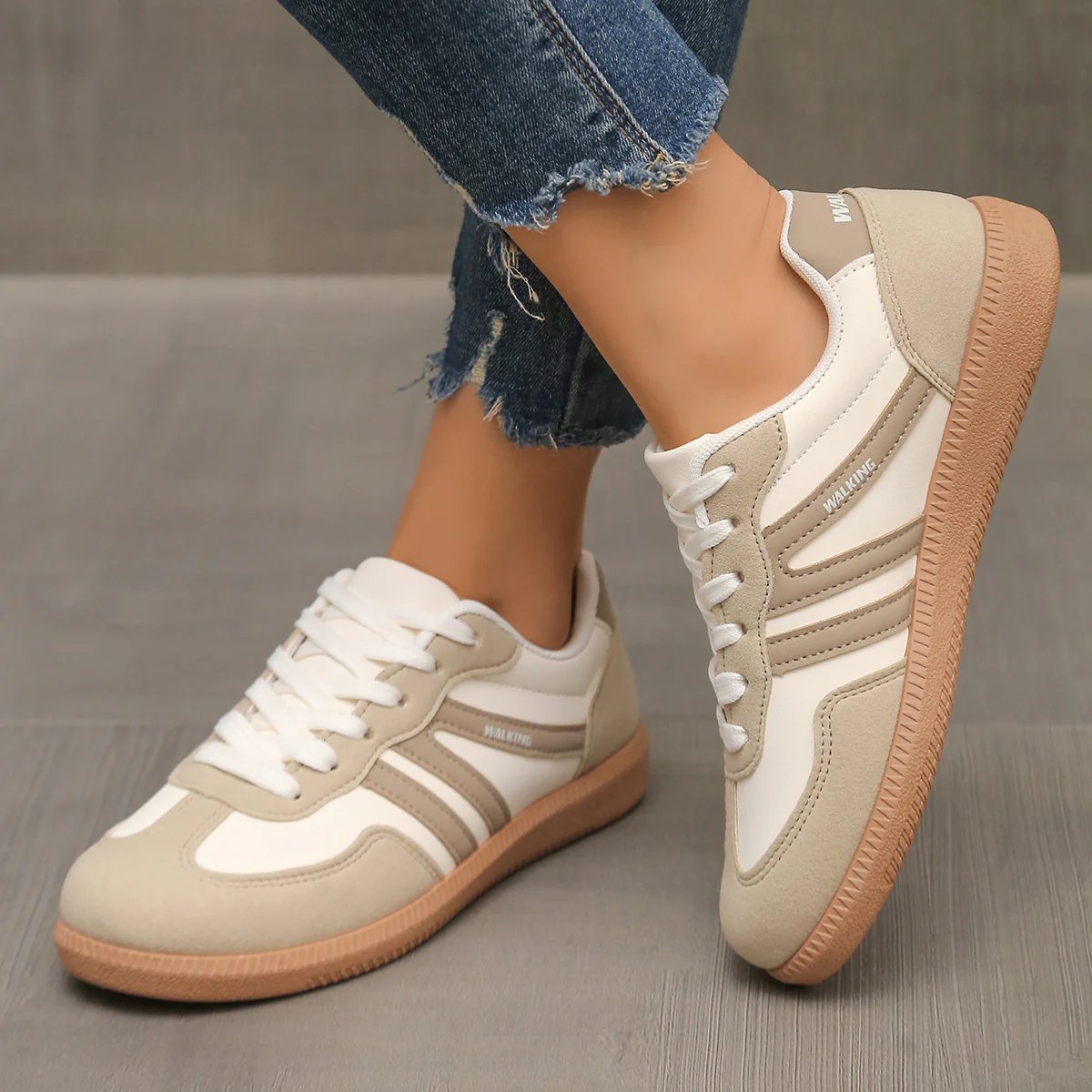 Side view of off-white Briony orthopaedic trainers with subtle branding on a clean background.