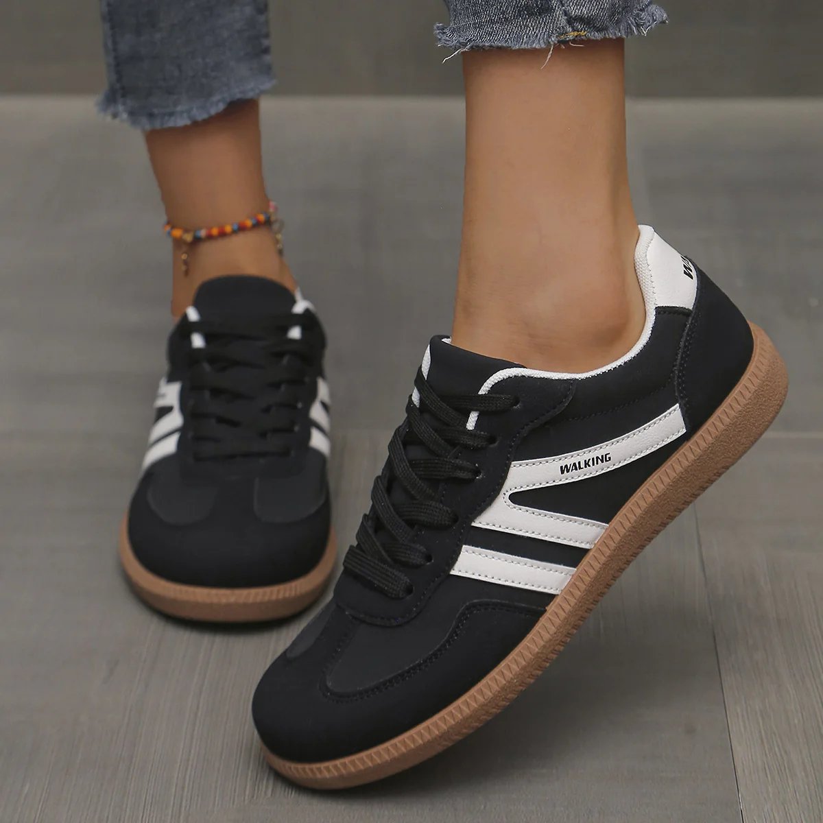 Front angle of off-white cushioned trainers, showcasing the breathable upper material and lace detail.