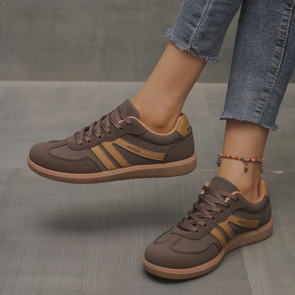 Black Briony orthopaedic trainers from a three-quarter angle, illustrating their sleek, versatile appearance.