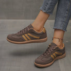 Black Briony orthopaedic trainers from a three-quarter angle, illustrating their sleek, versatile appearance.