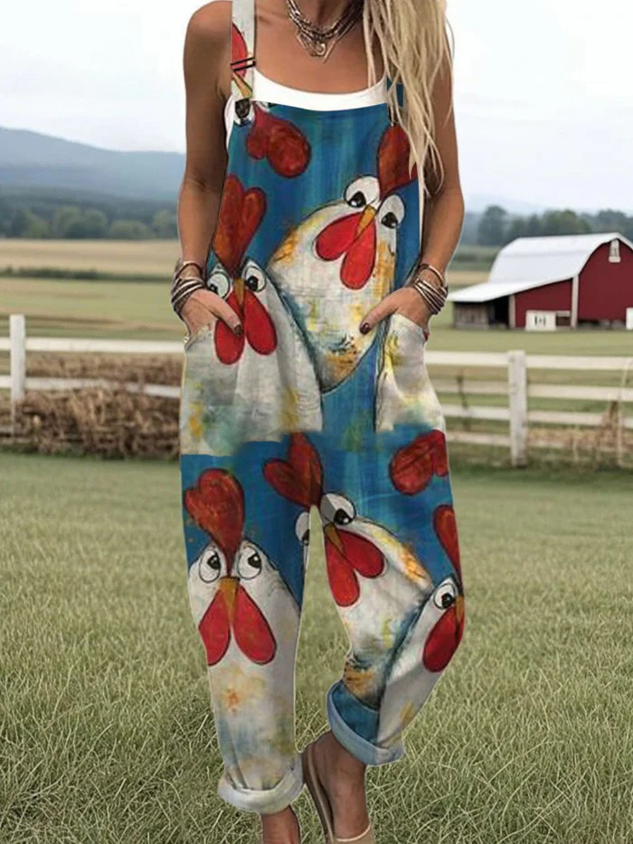 Front view of the Cassia playful chicken jumpsuit in blue with white chicken motifs, showcasing its relaxed fit and rolled cuffs.