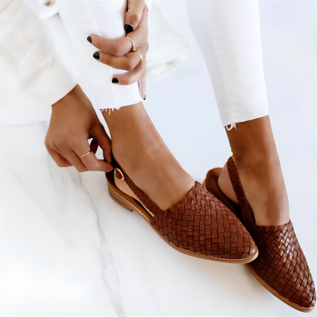 Pair of dark brown Elara handcrafted moccasins from a top-down angle, showcasing the intricate woven pattern and soft leather texture.