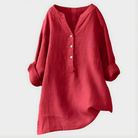 Front view of a woman wearing the Elara elegant cotton-linen blouse in watermelon pink, casually styled.