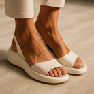 White Elara open-toe non-slip sandals, front view showing strap detail on a clean background.