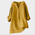 Flat lay of the folded Elara elegant cotton-linen blouse, showcasing its compact and travel-friendly nature.