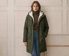 Front view of the berry red Elara waterproof parka, styled with winter accessories.