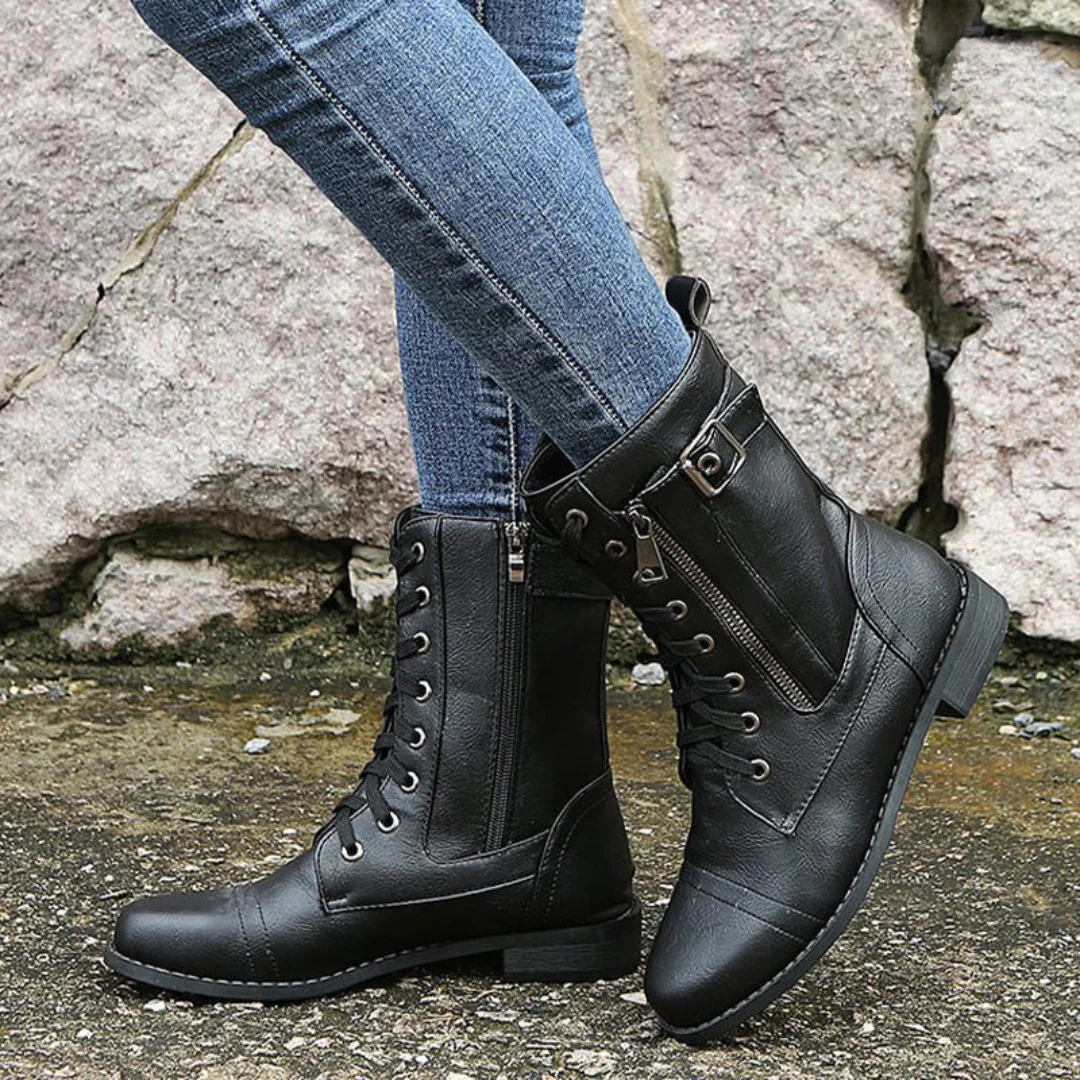 Full-body shot of a woman wearing the Elara orthopedic comfort boots, styled for a rainy autumn day, highlighting their waterproof design.