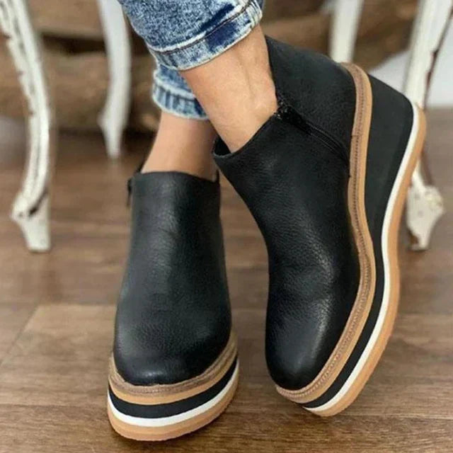 Overhead shot of a pair of beige Elara casual wedge ankle boots, emphasizing the sleek slip-on design.