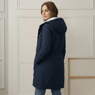 Close-up of the midnight navy Elara parka's waterproof fabric texture and quality stitching.