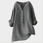 Side profile of a woman wearing the Elara elegant cotton-linen blouse in green, highlighting the relaxed fit.