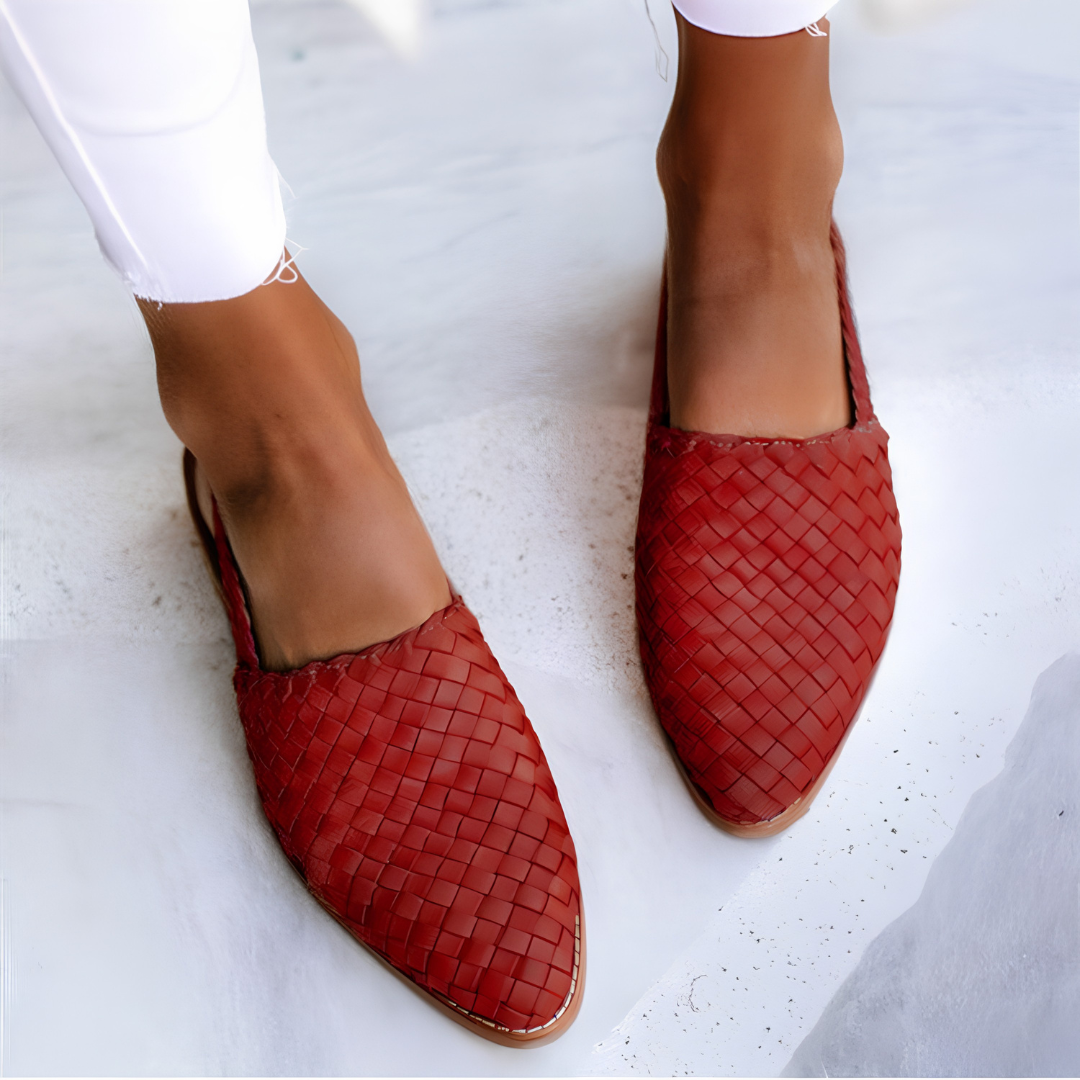 Close-up detail of the woven finish on a red Elara handcrafted moccasin, emphasizing the craftsmanship and material quality.