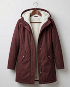 Detail shot of the berry red Elara parka's full-length zipper and button-down storm flap closure.