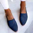 Overhead shot of blue Elara handcrafted moccasins arranged neatly, displaying the range of available colors and the consistent design.