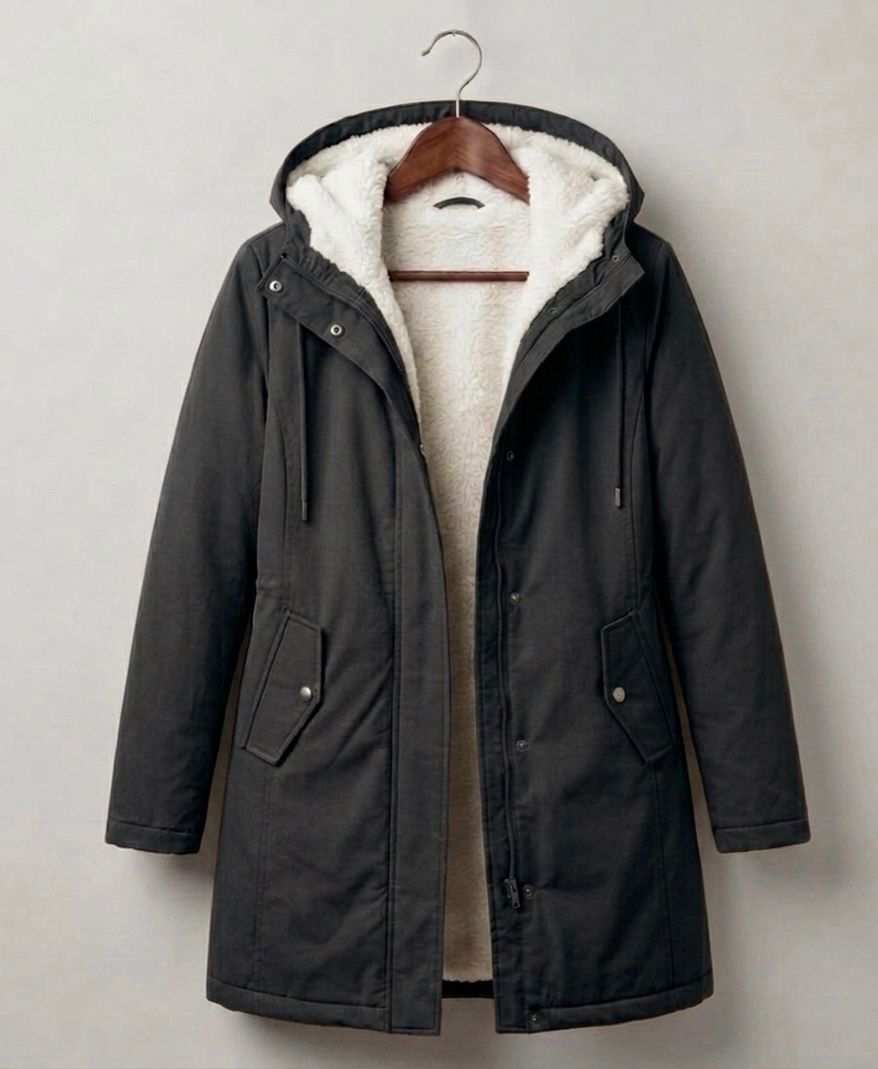 Close-up of the deep, fixed storm hood on the grey Elara waterproof parka, designed for maximum coverage.