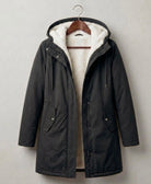 Close-up of the deep, fixed storm hood on the grey Elara waterproof parka, designed for maximum coverage.