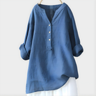 Woman walking outdoors, wearing the Elara elegant cotton-linen blouse in navy blue, comfortable and chic.