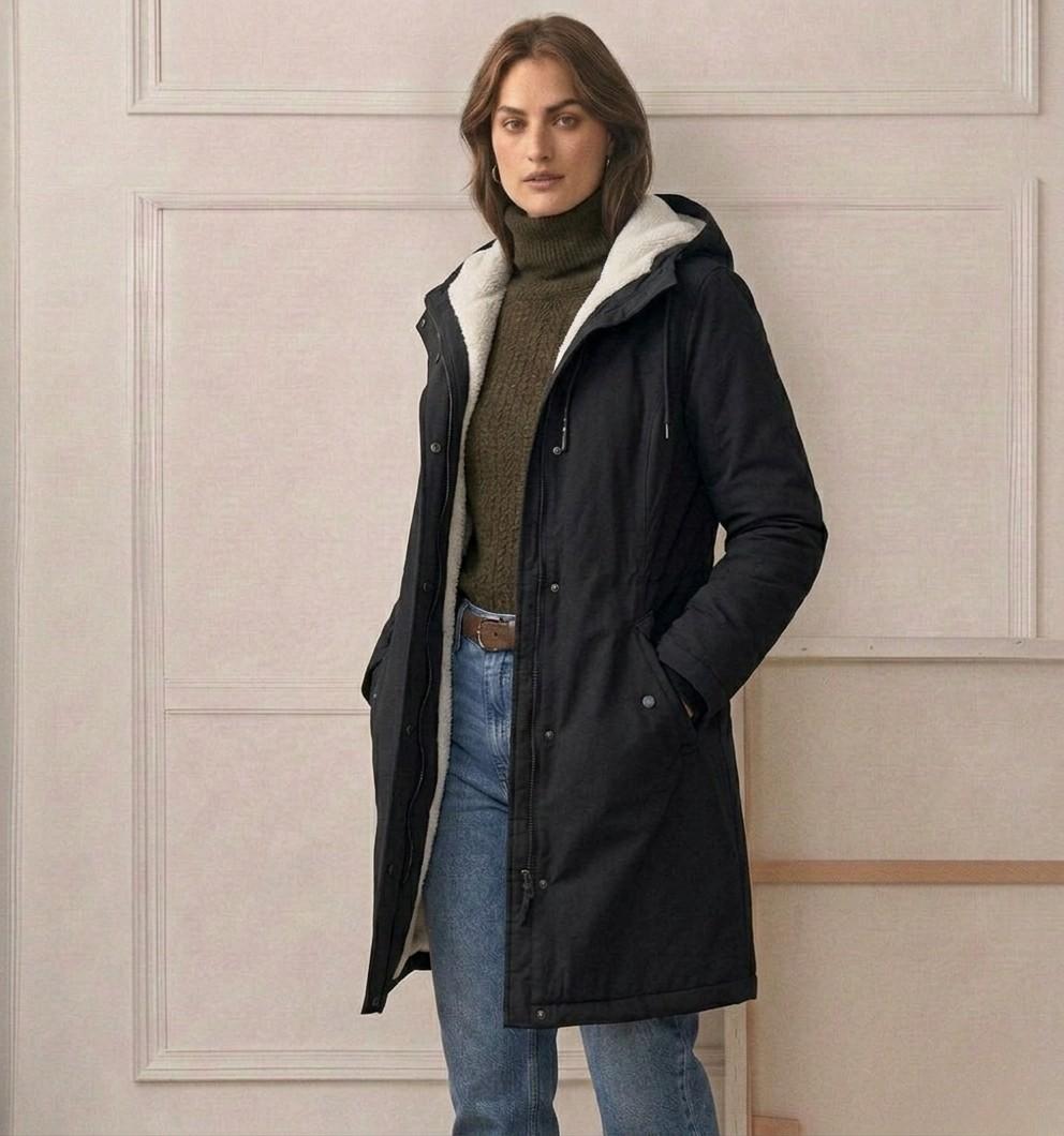 Three-quarter view of the black Elara parka, demonstrating its flattering tapered waist design.