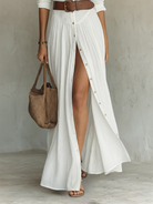 Side profile of the Paloma long sleeve linen blend maxi dress, highlighting the flowing pleated skirt.