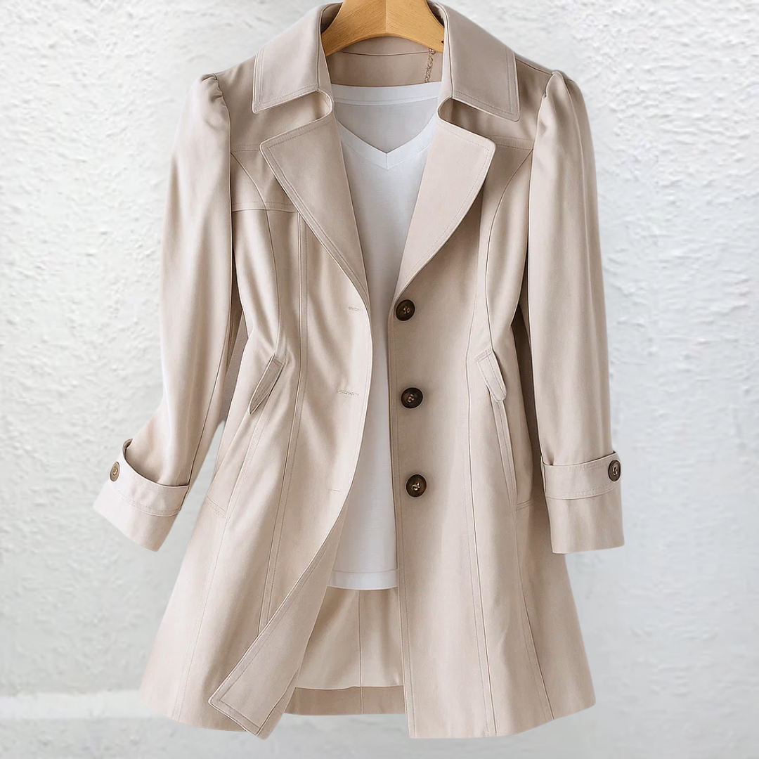 Close-up detail of the premium fabric and stitching of the beige Estelle elegant summer trench coat.
