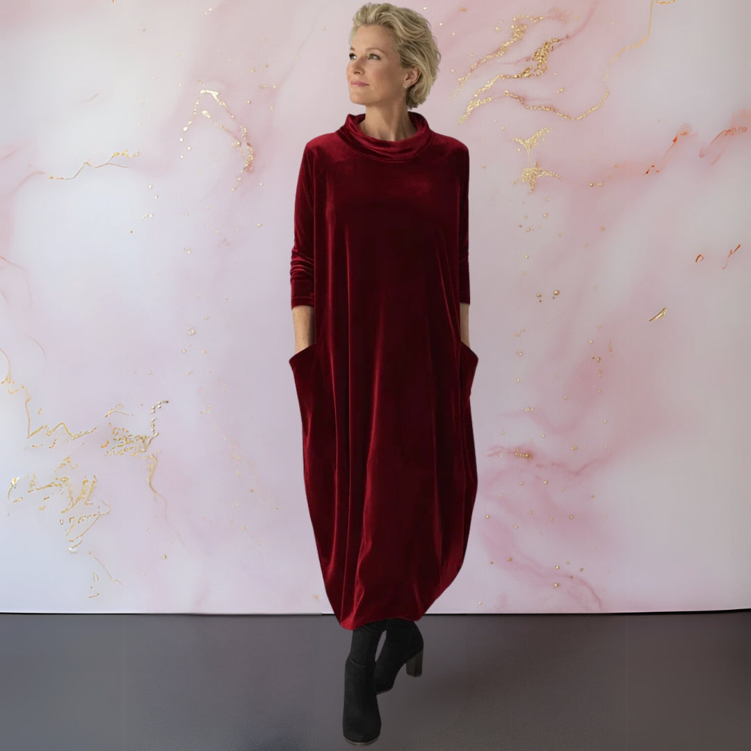 Close-up detail of the modern stand-up collar and soft texture of the luxurious velvet maxi dress fabric.