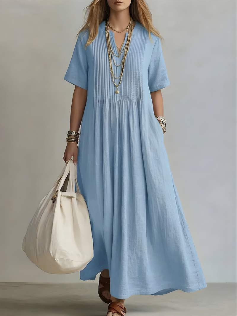 Side profile of a woman smiling in a yellow Estelle flowing maxi dress, demonstrating its relaxed and comfortable fit.