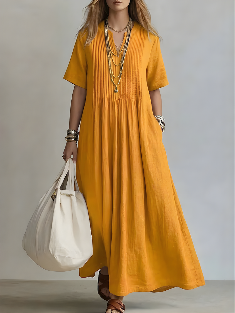 Back view of the green Estelle flowing V-neck maxi dress, emphasizing the full length and unhindered movement.