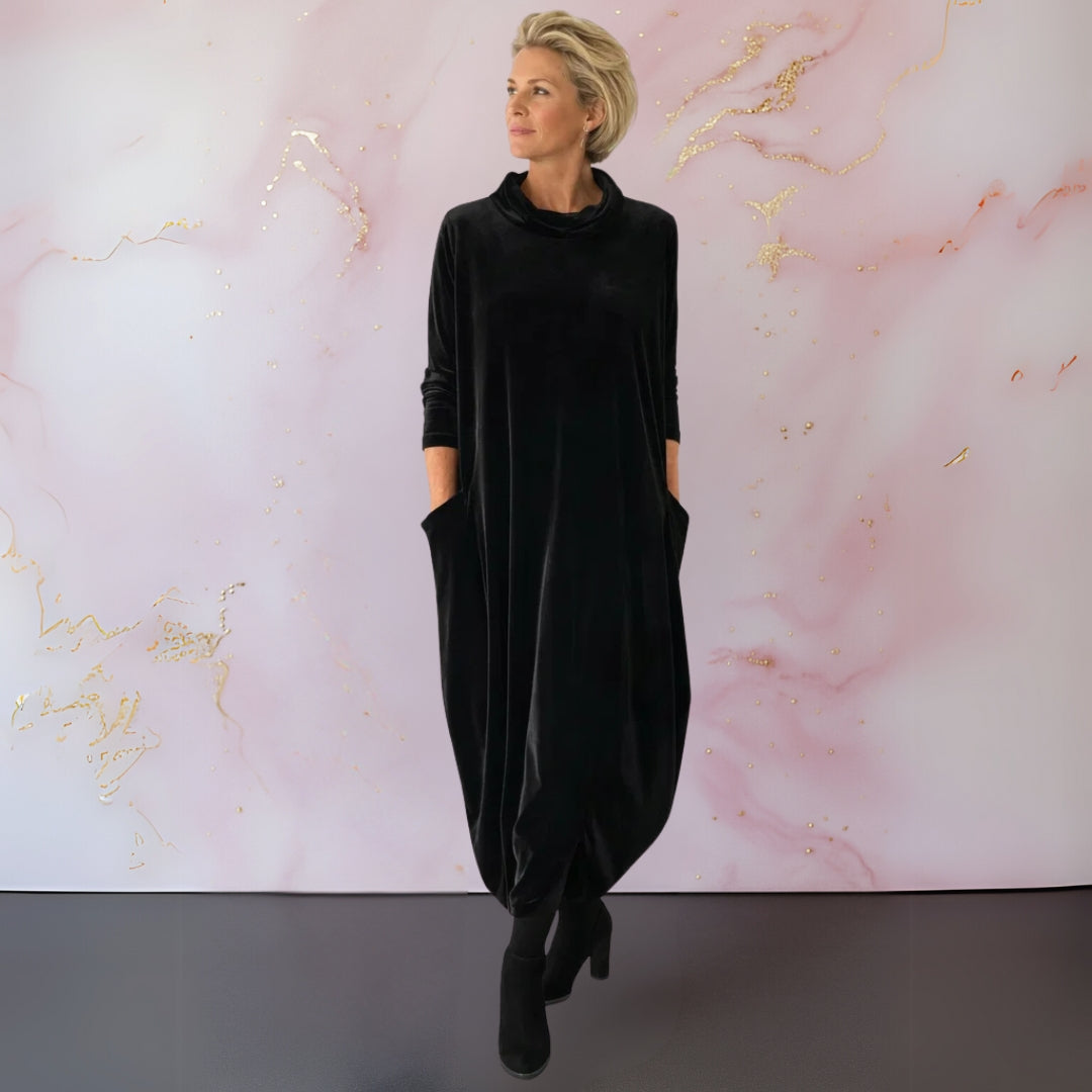 Back view of the purple elegant velvet maxi dress, demonstrating the graceful fall of the material.