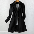 Woman walking in a city park, wearing the khaki Estelle elegant summer trench coat with casual attire.