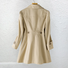 Detail shot of the button closure and collar on the black Estelle elegant summer trench coat.