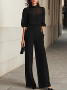 Front view of the Evelyn black chiffon camisole and wide-leg pants set, showcasing the sheer top and flowing silhouette.