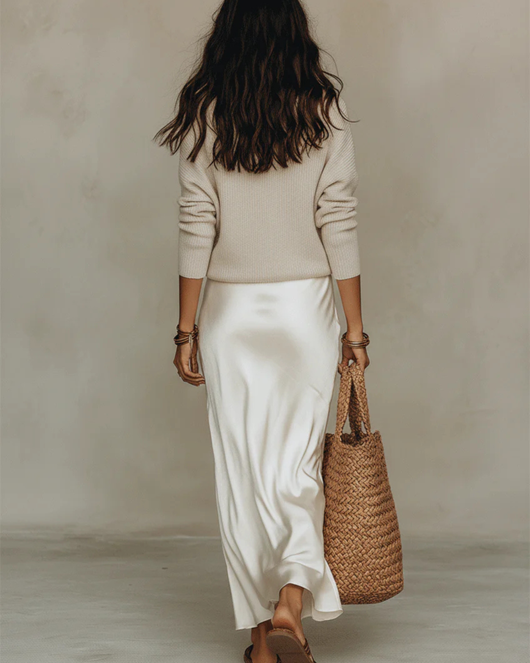 Side profile of a model wearing the Genevieve two-piece set, highlighting the flattering silhouette and midi length.