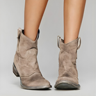 A pair of brown Hadley vintage cowboy ankle boots, showcasing the pointed toe and intricate stitching details.