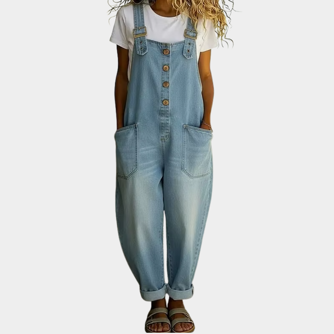 Front view of a woman wearing the Hadley soft denim overalls in light blue, showcasing the relaxed fit and adjustable straps.