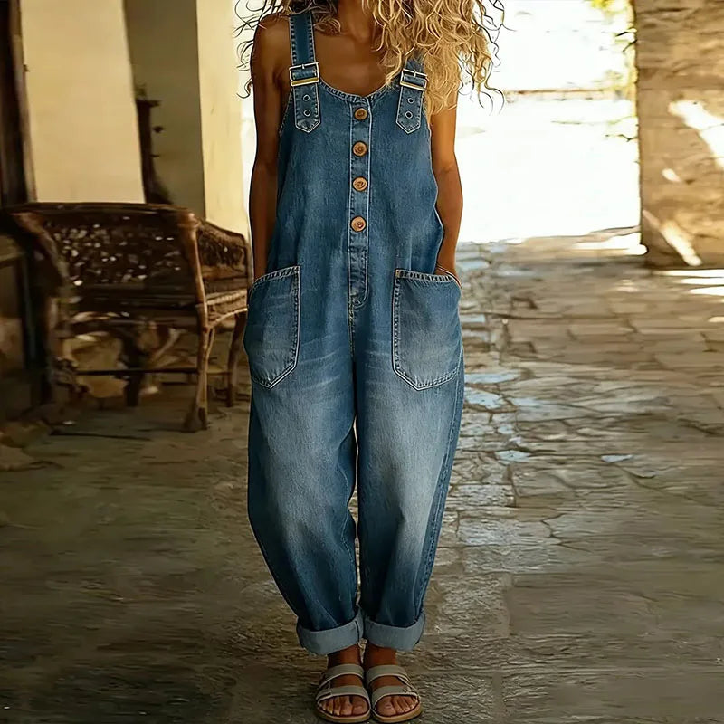 Side profile of a model styling the Hadley wide-leg denim overalls, demonstrating the comfortable drape and silhouette.
