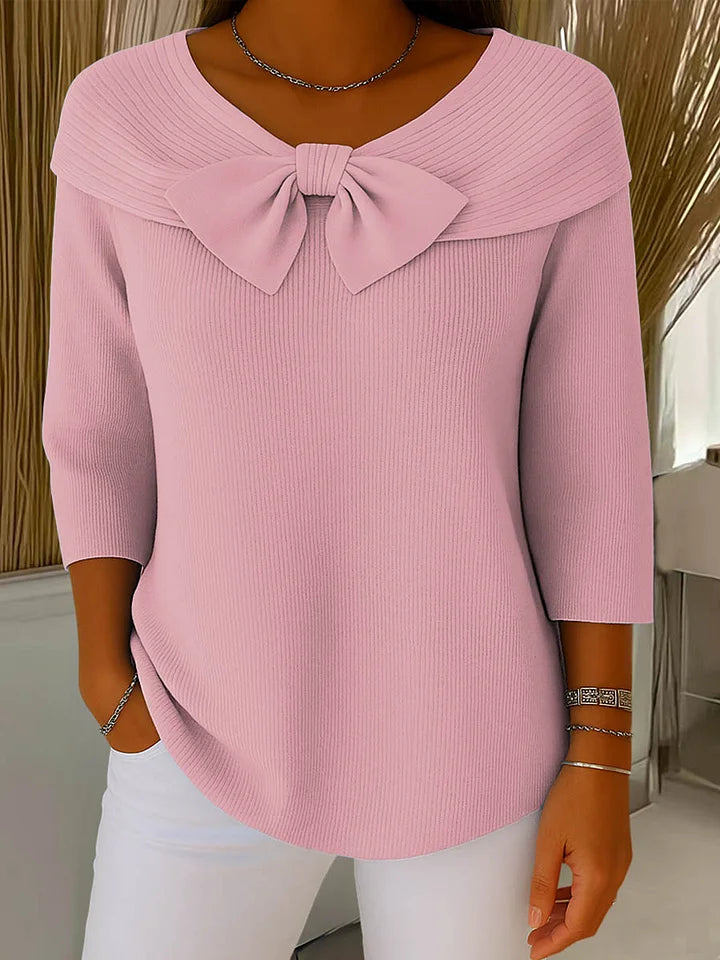 Side profile of a model wearing the Isolde elegant knitted top in black, highlighting its flattering drape and fit.