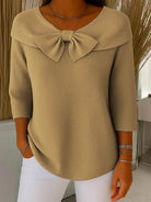 Close-up detail of the bow on the Isolde elegant knitted top, emphasizing the quality knit and refined design.