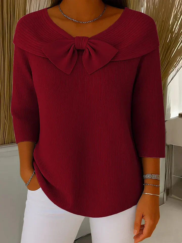Lifestyle shot of the Isolde elegant knitted top worn with tailored trousers, demonstrating its versatility for office wear.