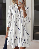 Close-up detail of the wavy collar and button placket on the white Hadley dress, highlighting the fabric texture.