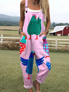 Front view of the Juniper playful printed jumpsuit in pink with a whimsical chicken pattern, showcasing its relaxed fit and cropped legs.