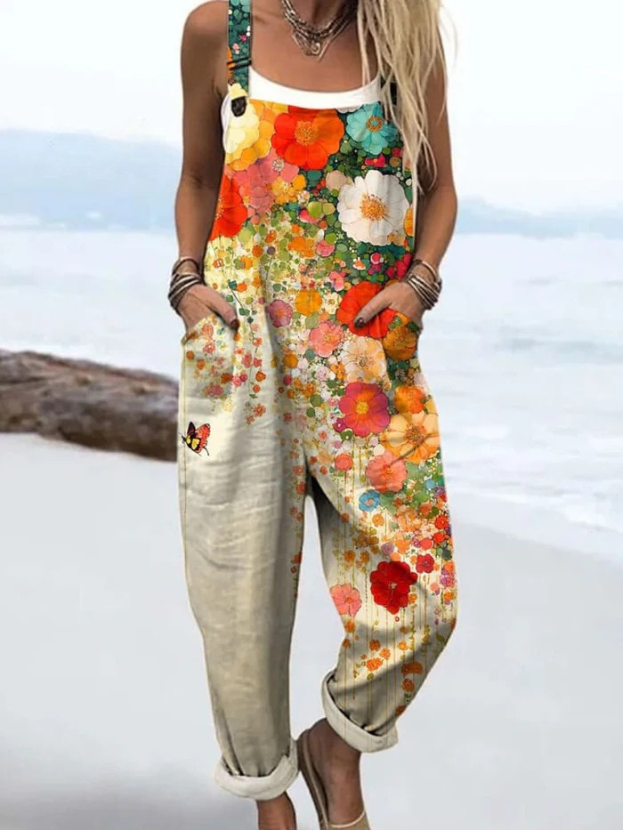 Front view of the Kaelen Floral Breeze Jumpsuit, showcasing its relaxed fit and vibrant orange, white, pink, and turquoise floral pattern.