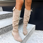 Close-up of the elegant dark brown Kalina knee-high suede boots, highlighting the soft texture and precise stitching.
