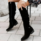 Overhead view of two pairs of Kalina knee-high suede boots in contrasting colors, arranged artfully to show material quality.