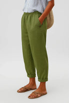 Side profile of the Kallista trousers in an olive green, highlighting the comfortable elastic waistband.