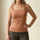 Detail of the bottom hem on the nude Keisha comfort bra tanktop, showing its finish.