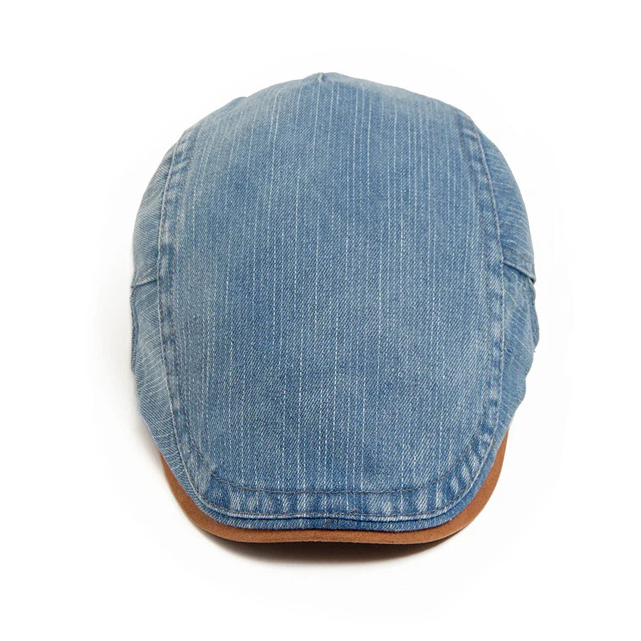 Detail shot of the cap's brim, emphasizing the sturdy construction and subtle stitching of the premium denim flat cap.
