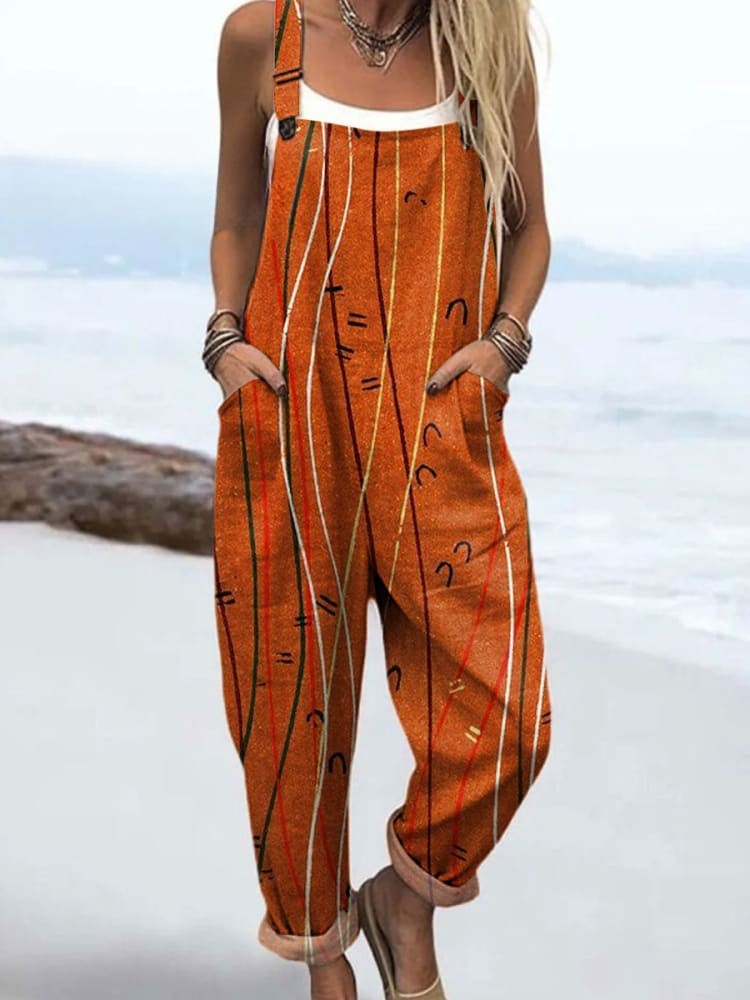 Front view of a woman wearing the Kiana artistic line jumpsuit, showcasing its burnt orange color and abstract pattern with wide-leg design.