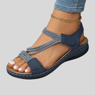 Pair of light pink Liana orthopedic comfort sandals displayed from a front-top angle, showcasing the adjustable straps and cushioned footbed on a clean background.