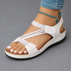 Detail shot of the adjustable hook-and-loop closure on a white Liana orthopedic comfort sandal, emphasizing ease of wear and secure fitting.